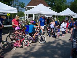 Children wait for a bike safety check at the Bike Rodeo