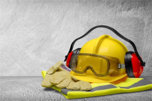 Image of a hard hat, gloves, ear phones, googles and a vest