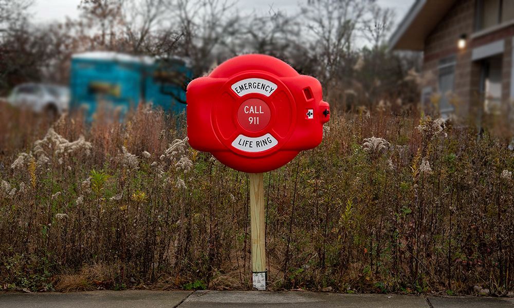A photo of the Forest Preserve's throwable life preserver ring and alarm at Silver Lake