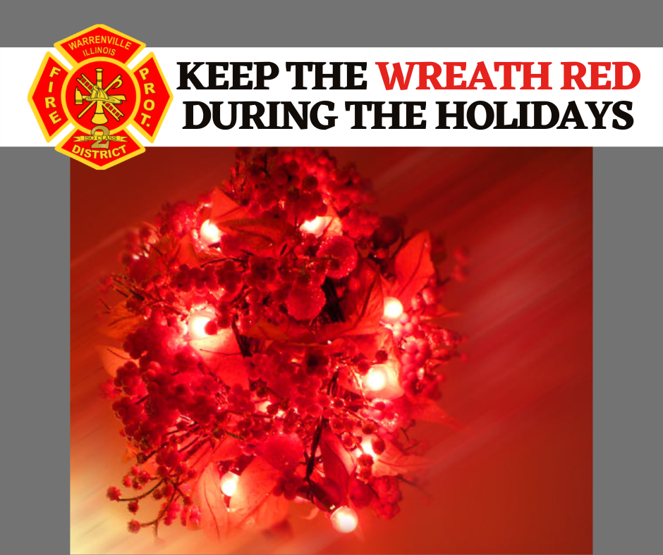 A photo of a wreath with red holiday lights.