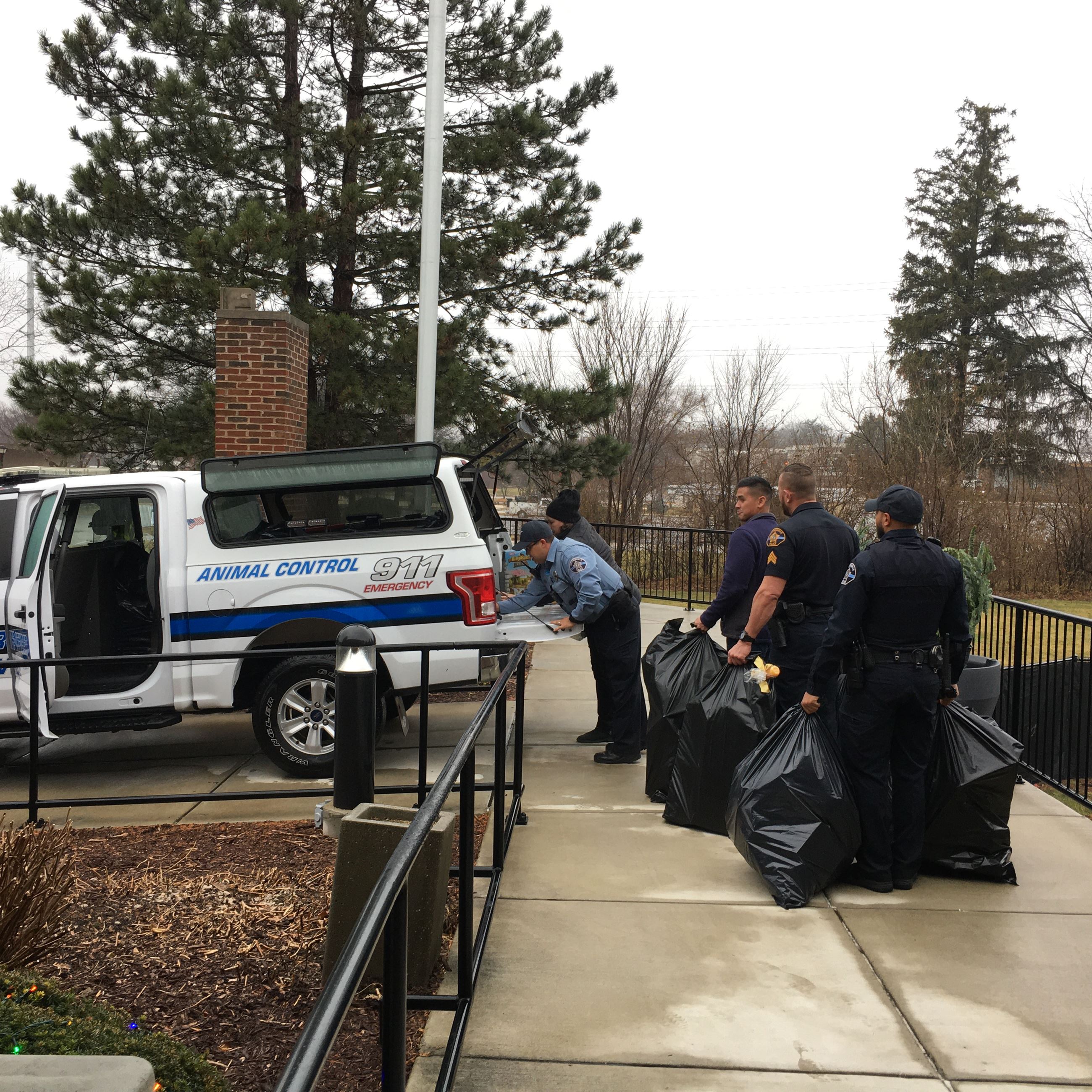 Loading a police truck with bags of toys for Toys for Tots