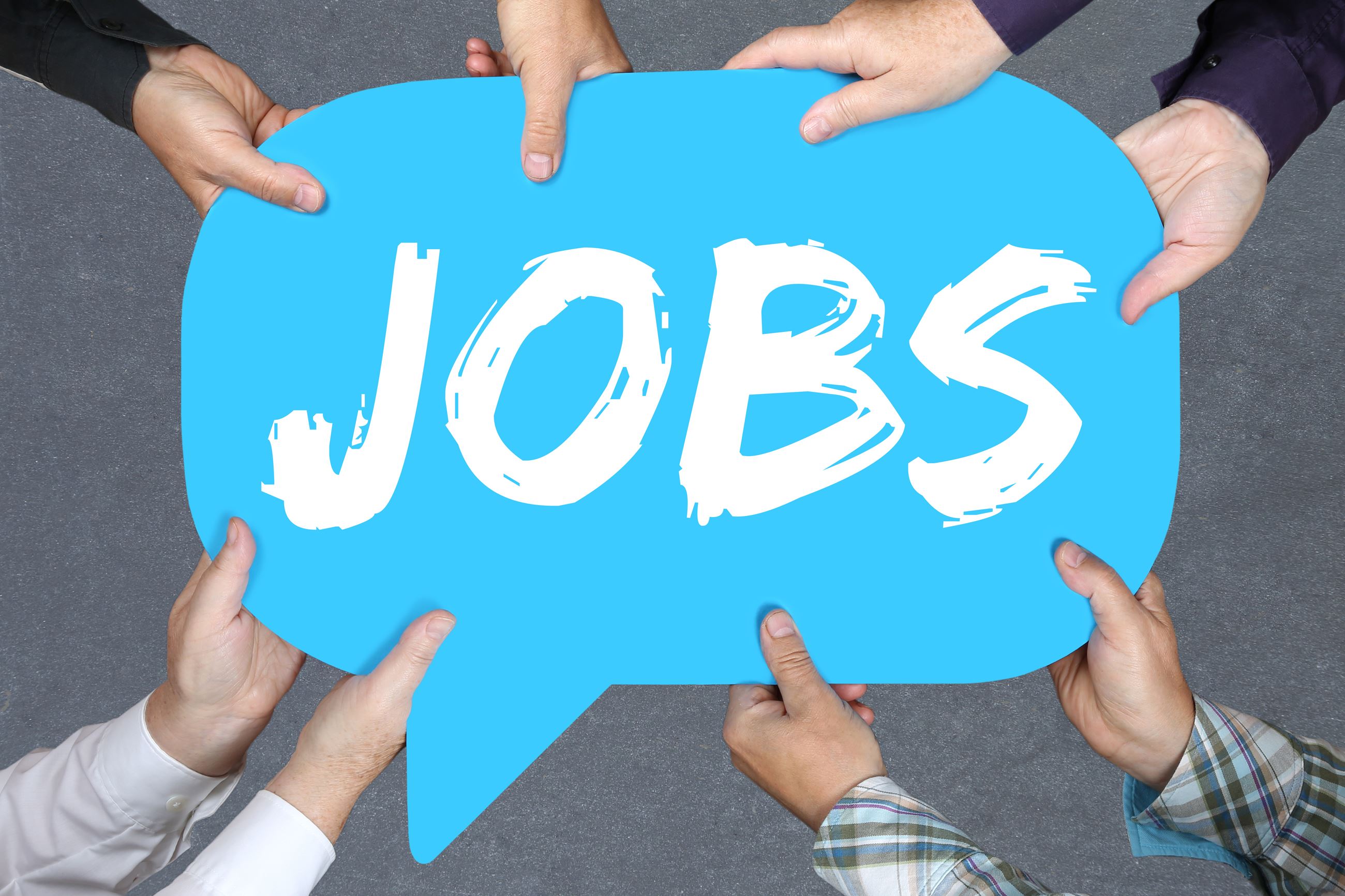 A photo of hands holding a sign that says 