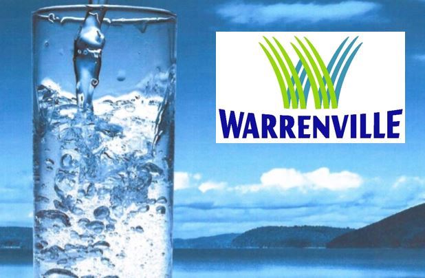 Photo of water glass with lake and mountains in the background with the City of Warrenville logo. 