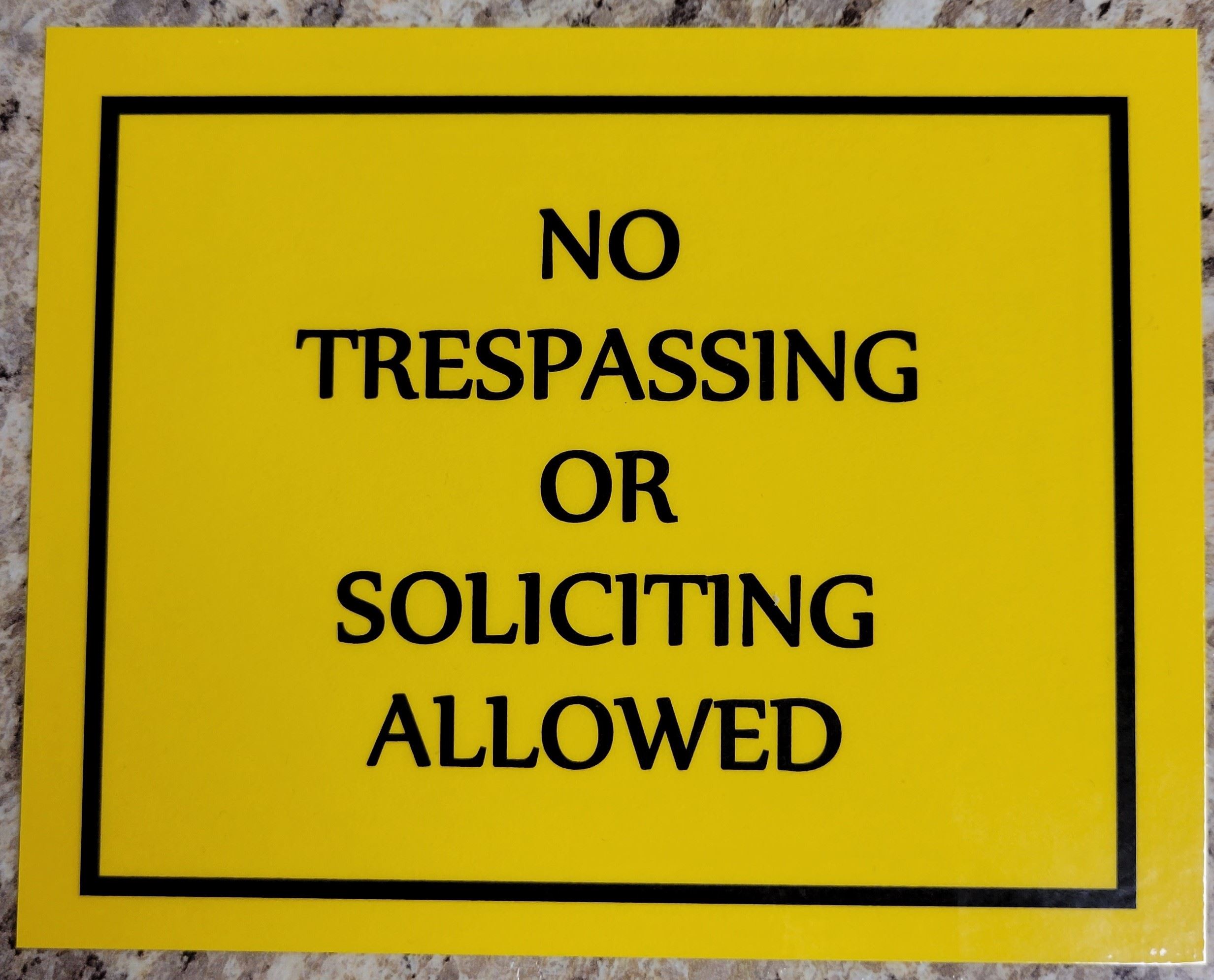 No trespassing or soliciting allowed notice.
