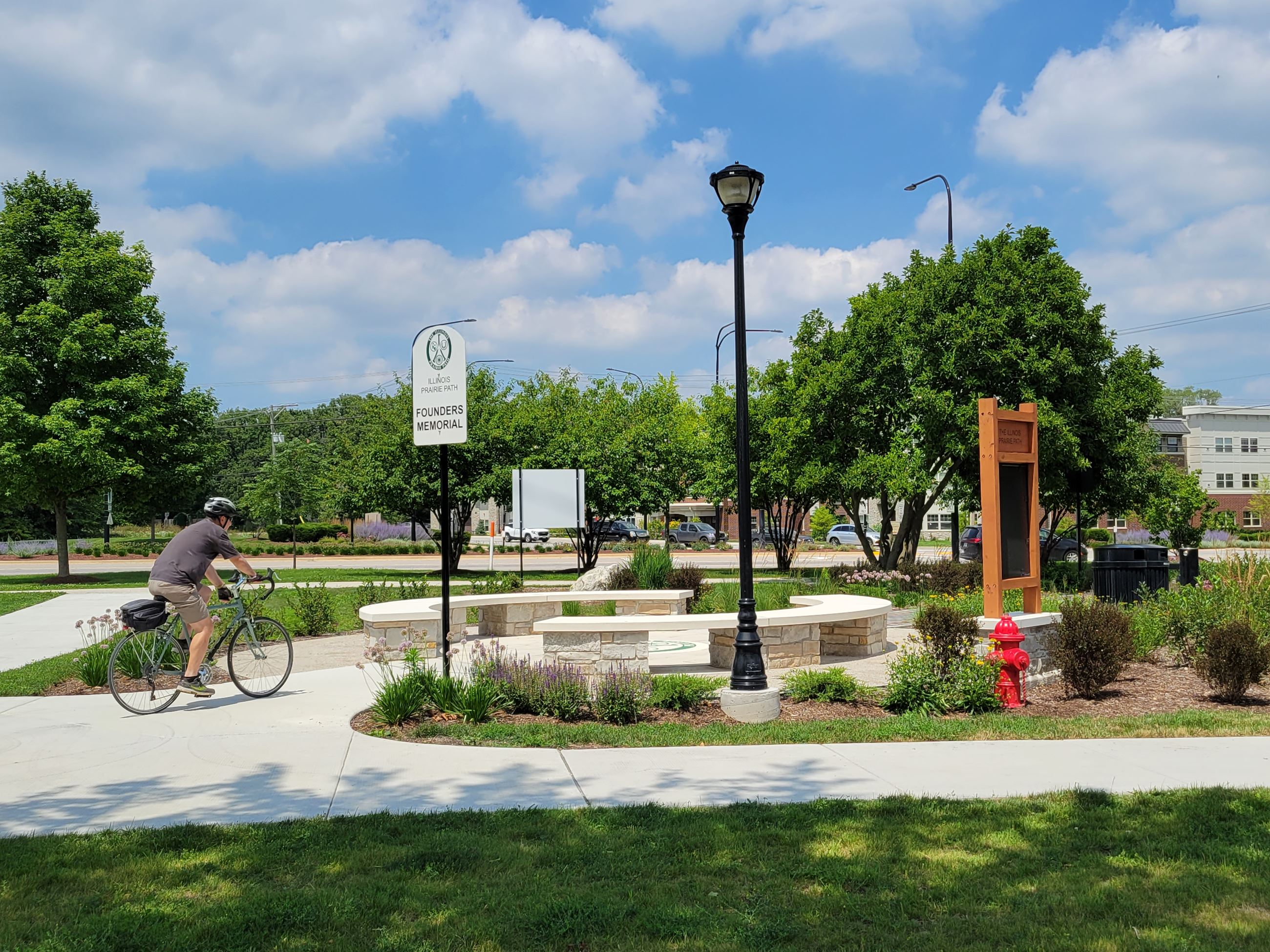Bicyclist at the Founders Memorial on the Trailhead Bike Path