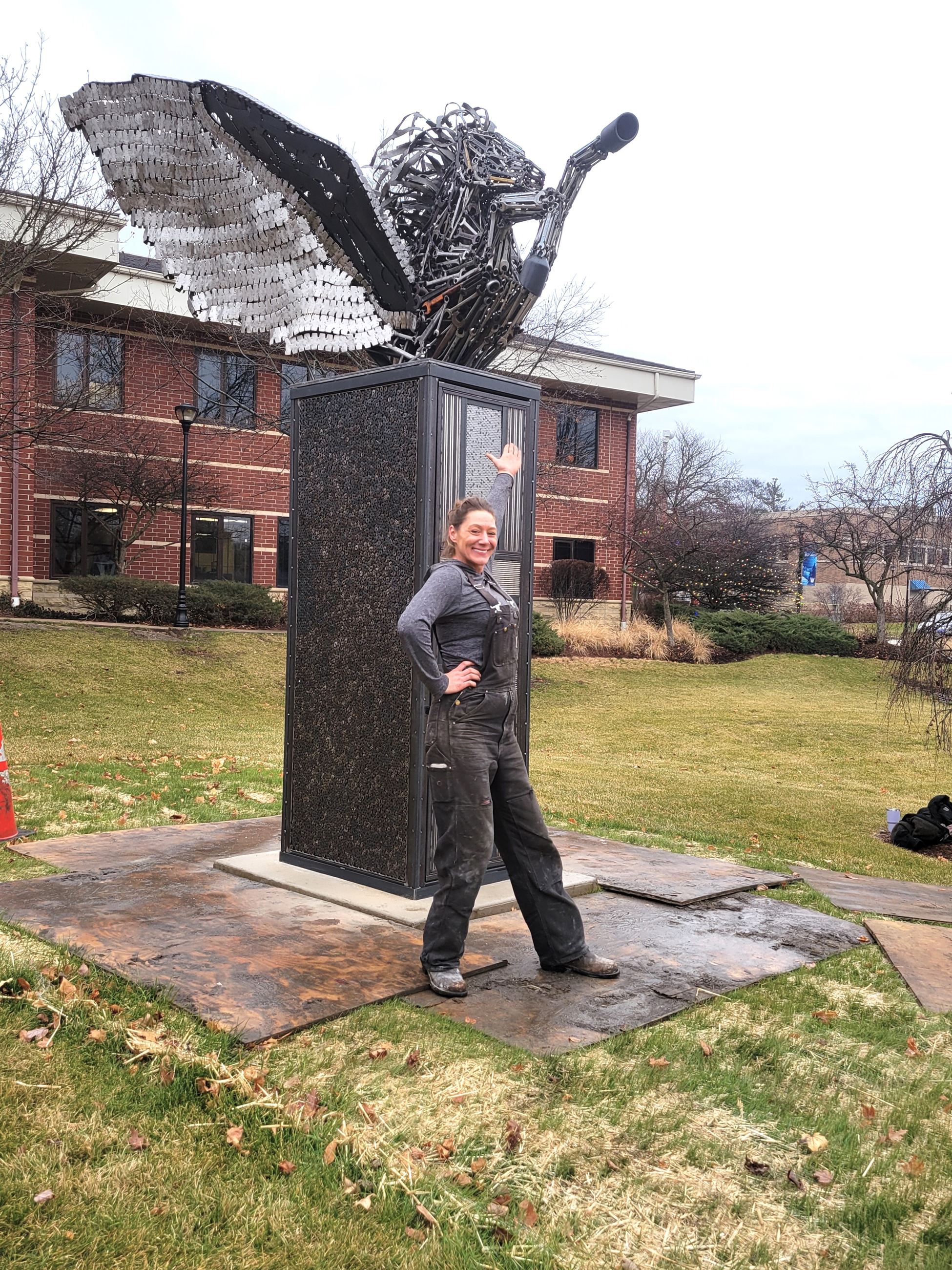 Jen Kresl with her Pegasus steel sculpture